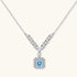 Sterling silver necklace with geometric crystal arrangement forming a V-shape and square blue moissanite centerpiece pendant